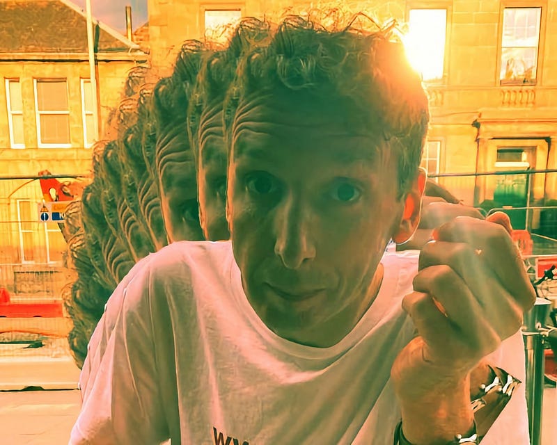 A quirky portrait of artist Simon Knox, with an exaggerated motion blur effect creating multiple silhouettes of his profile. His expression is lively and playful and he’s making a fist. The background hints at an urban setting bathed in a warm, golden light, suggesting it could be late afternoon. He’s wearing a casual white tee and the photo exudes a sense of creative energy and movement.