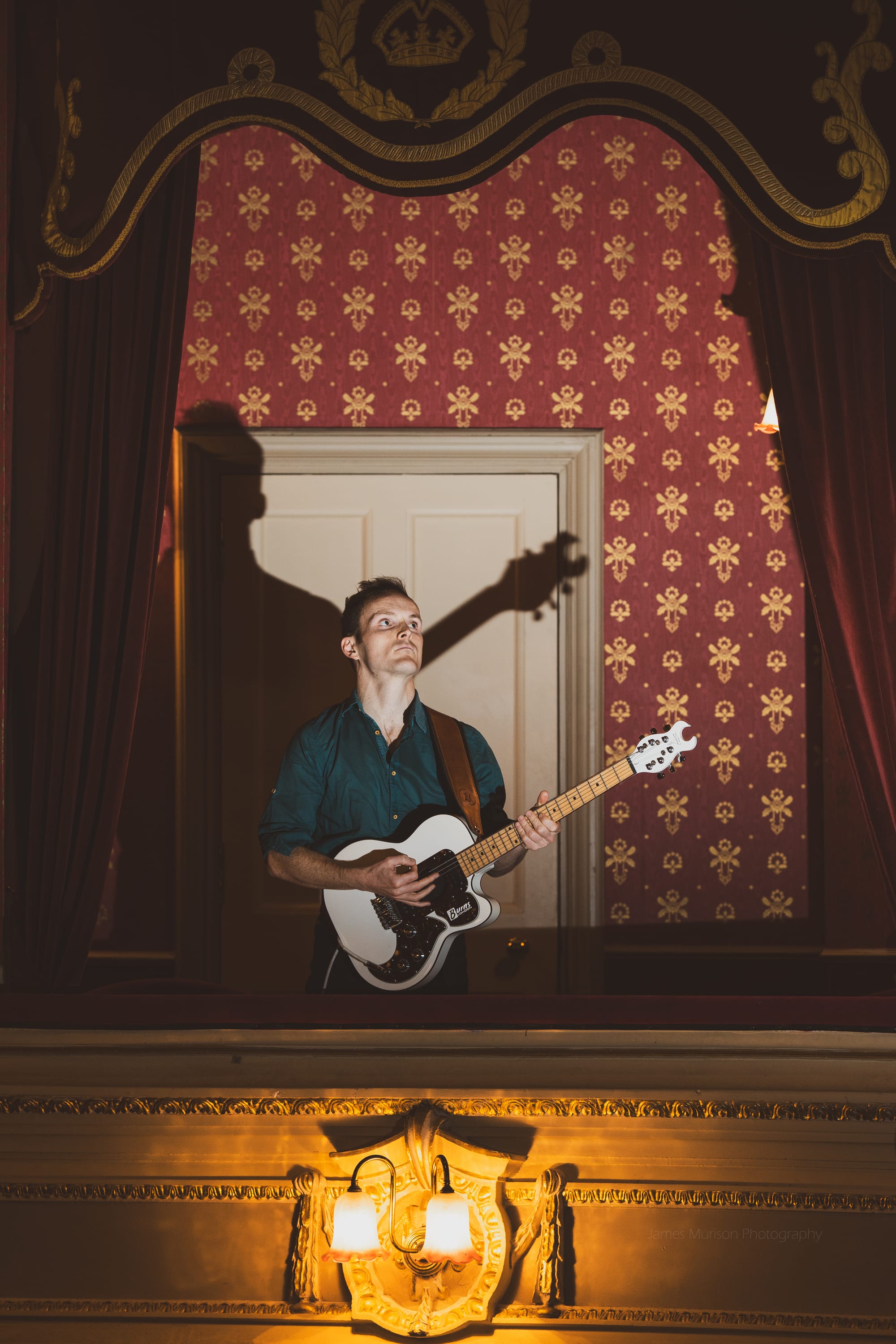 Oliver Richard playing guitar in a box at His Majesty's Theatre