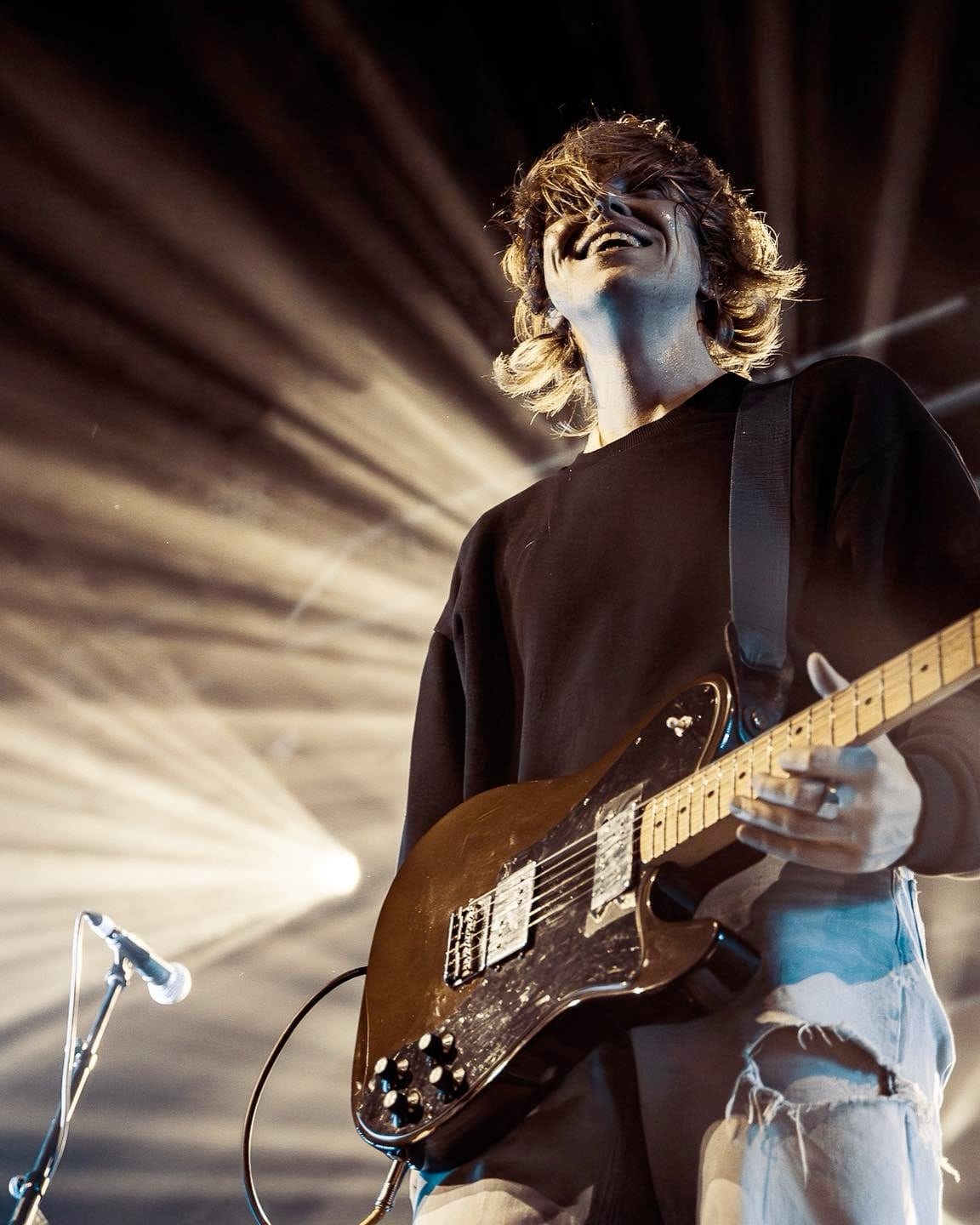 Murray Macleod performing with guitar, head tilted back singing