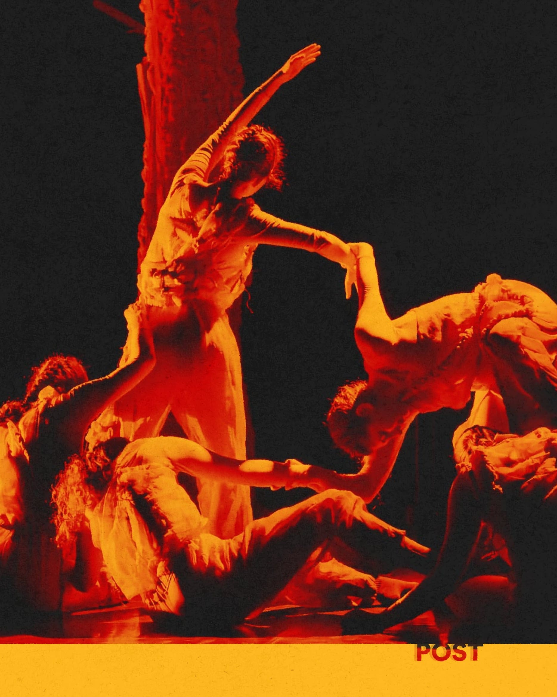 Red-toned photo of dancers in frayed costumes entangled on stage beside a tree trunk.