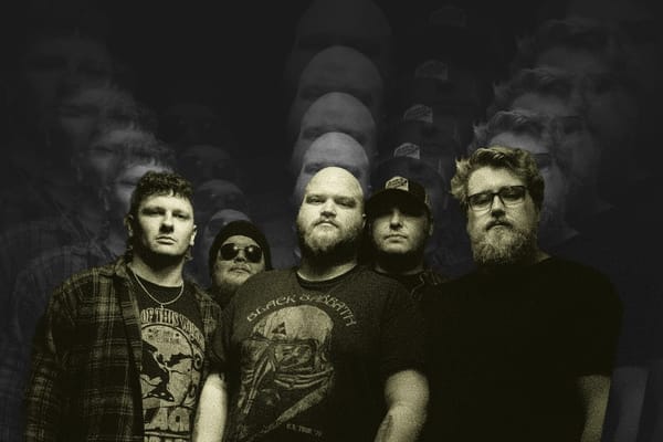 Five members of Atomic Mother in layered black graphic, serious expressions and band tees.