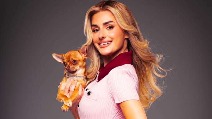 Amber Davies as Elle Woods holding a chihuahua with diamond collar