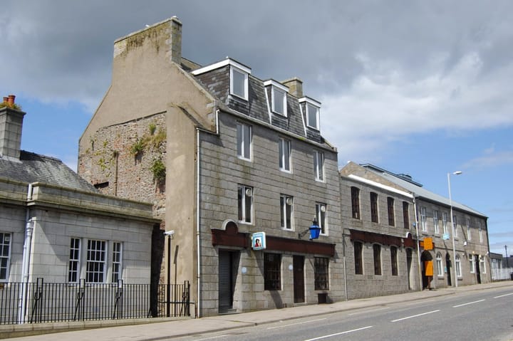 The Blue Lamp pub, a two-storey grey granite building with dormer windows on Gallowgate in Aberdeen,